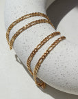 14k Gold Fill Gigi Necklace laid on a white plate in the sunlight.