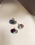 sterling silver bezel pendants with oval fluorite cabs on a light dish