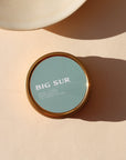 blue candle tin in the scent Big Sur in the sunlight