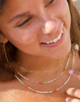 Model wearing full strand beaded necklace with moonstone, chrysoprase, and carnelian gemstones