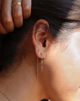 model wearing 14k solid gold stud earrings paired with 14k gold fill chain stud earrings