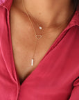 14k gold fill lariat necklace with heart and mother of pearl bead on model layered with mother of pearl heart necklace