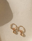 14k gold fill heart charm on simple hoop earring in sunlight