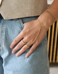 model wearing 14k gold fill hand chain with pearls