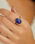 Lapis Lazuli Gemstone Ring in 14k gold fill photographed on a model. This ring features a thick gold hammered band with a 12x16mm Lapis gemstone.