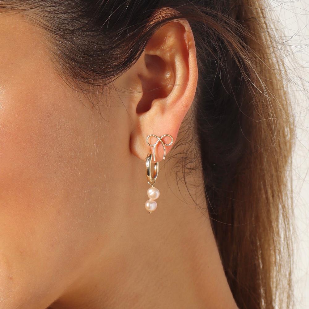 Mini Bow Earrings by token jewelry on model