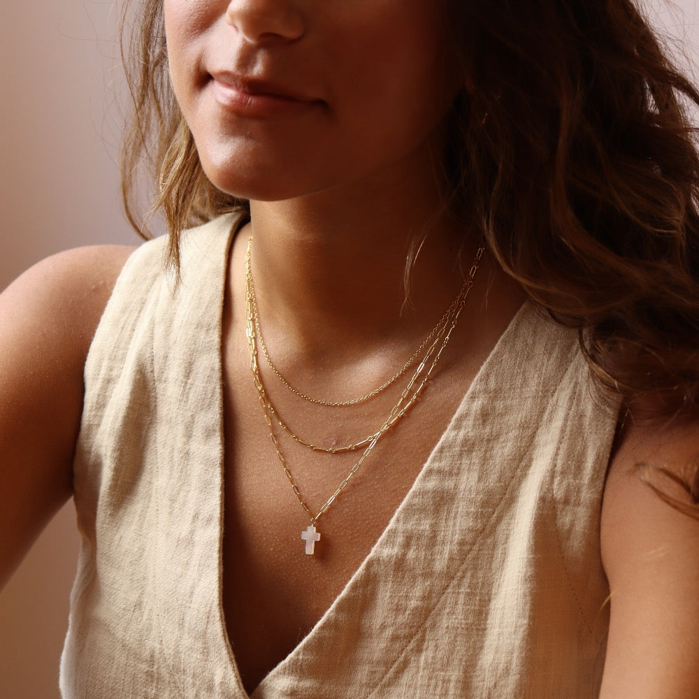 Model wearing Mother of Pearl Cross Necklace in 14k gold fill