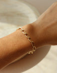 Model wearing the Curve Bracelet in 14k gold fill bracelet.