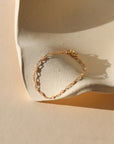 14k gold fill chain alternating with transparent opal gemstones as a bracelet in the sunlight