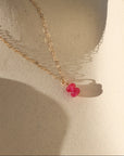 pink topaz charm in 14k gold fill on petite heart chain - light background with shadows