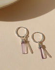 sterling silver hoop earrings with pink amethsyt charms and sterling silver chain on a light background