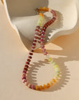 multi colored beads with pearls necklace on wavy plate in the sunlight