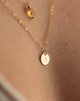 model wearing 14k gold fill dainty chain necklace with hand stamped circle charm