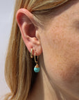 Model wearing Faceted turquoise gemstone charm for hoop earrings, shown with and without 16mm Goldie Hoops. A versatile Earring Bar add-on.