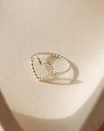 sterling silver spiral wire heart shaped ring on a light dish