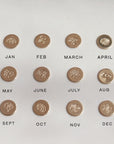 Examples of each birth flower available to be hand stamped onto a keepsake ring, including roses, carnations, daisy, lotus, poppy, among others.