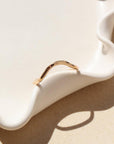 Plunge ring laid on a white plate in the sunlight