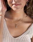 Model Wearing Flynn Mini Toggle Necklace.  This Necklace Features a Simple Toggle connector with a Dangle Fluorite tube gemstone . The toggle is held together with the Sylvie chain.