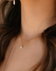 model wearing 14k gold fill floating pearl necklace.