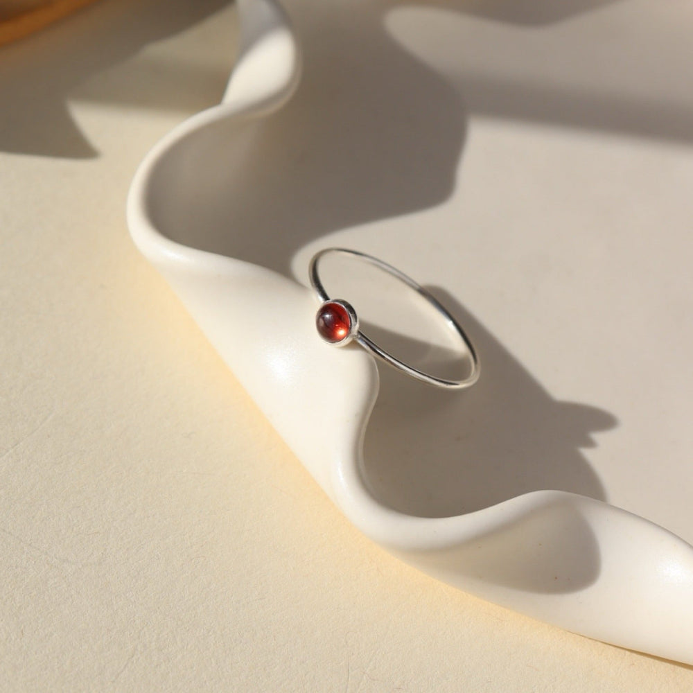 Sterling silver simple ring band with a 4mm red garnet stone