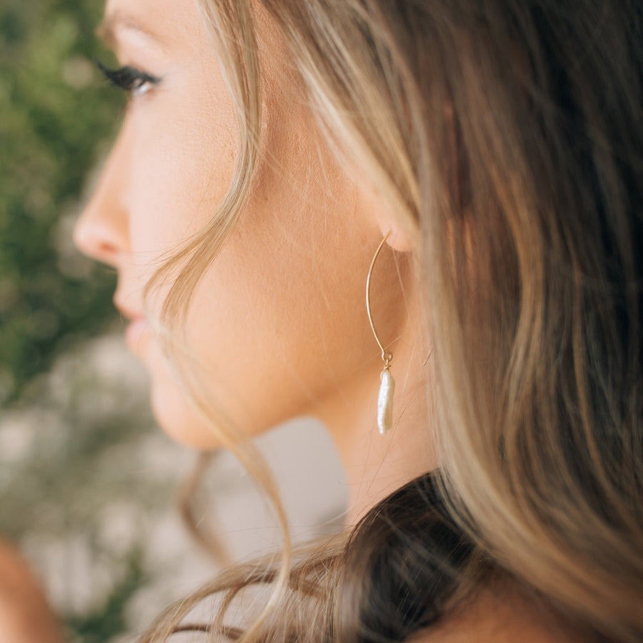 Model wearing 14k gold fill Juno earrings