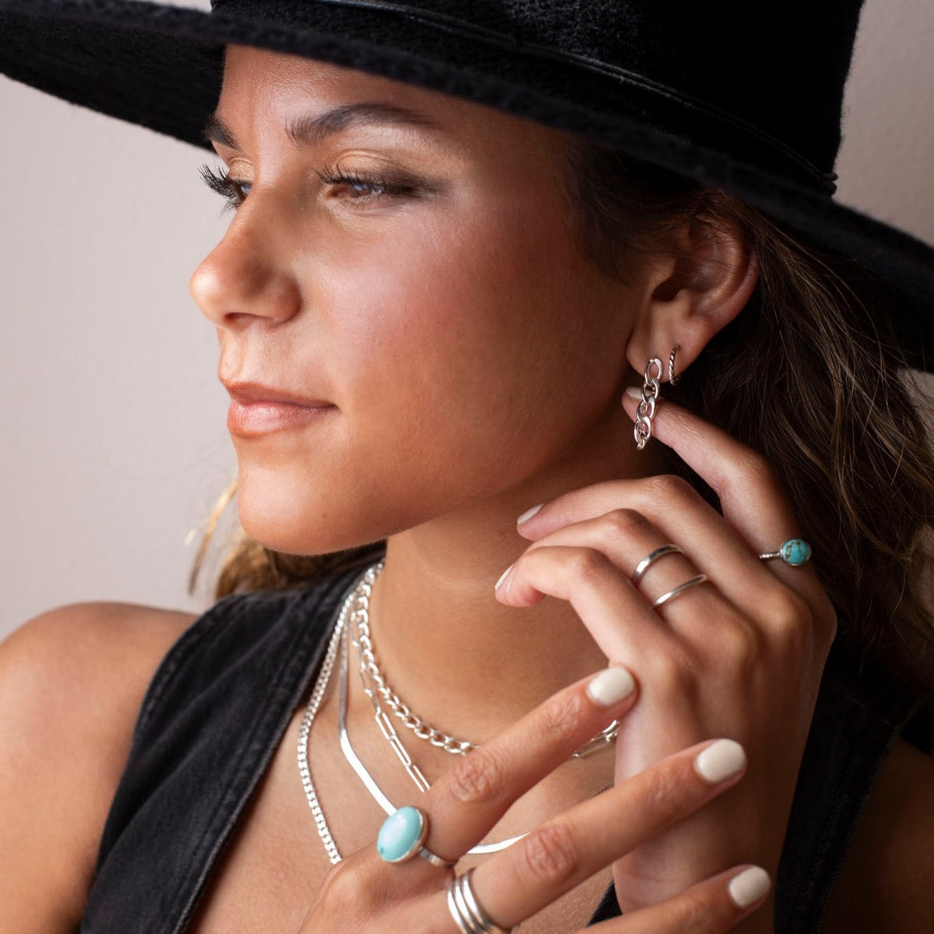 model wearing sterling silver chain studs with other sterling silver jewelry