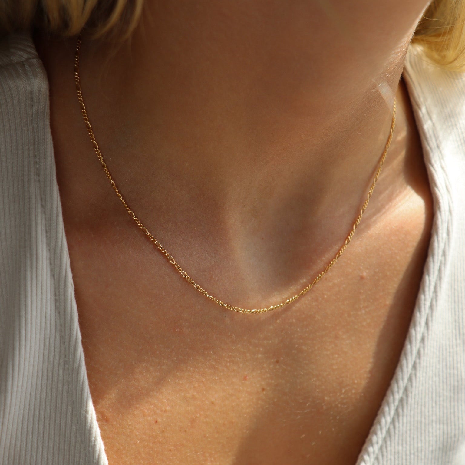 model wearing 14k gold fill figaro chain necklace 