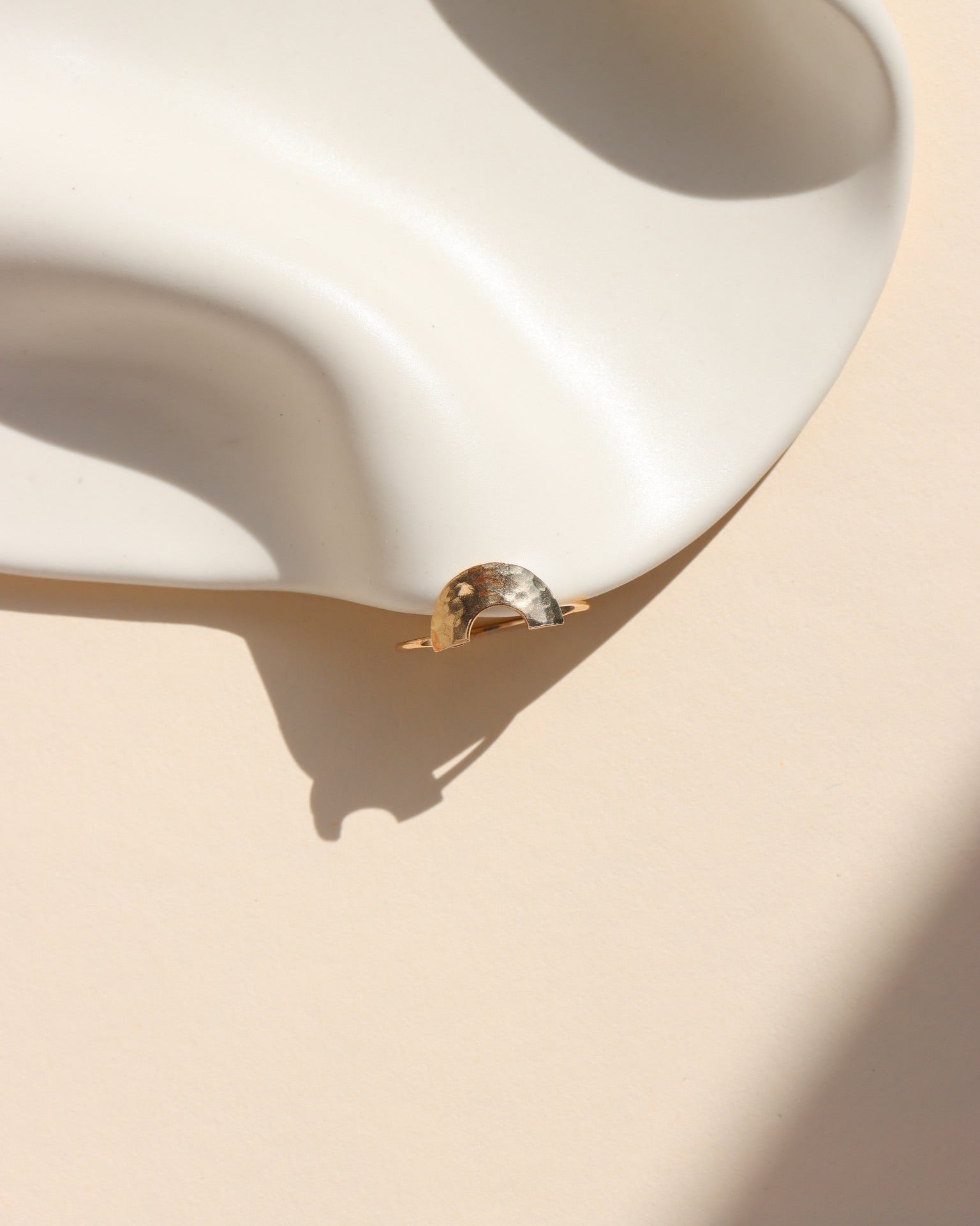 Curved hammered stacking ring in gold fill with a rainbow-like arc shape