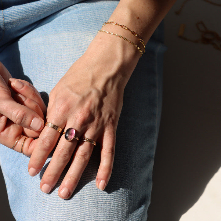 model wearing 14k gold fill rings with fluorite stone paired with a chain bracelet