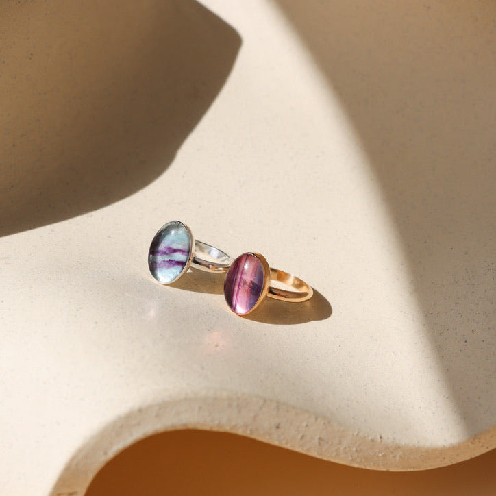sterling silver and 14k Gold Fill rings with handset fluorite stones on a light dish