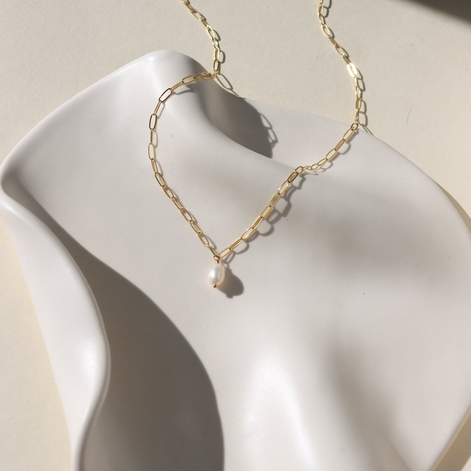Elegant Ava Pearl Necklace crafted in 14K gold fill, showcasing timeless simplicity with a glowing freshwater pearl.