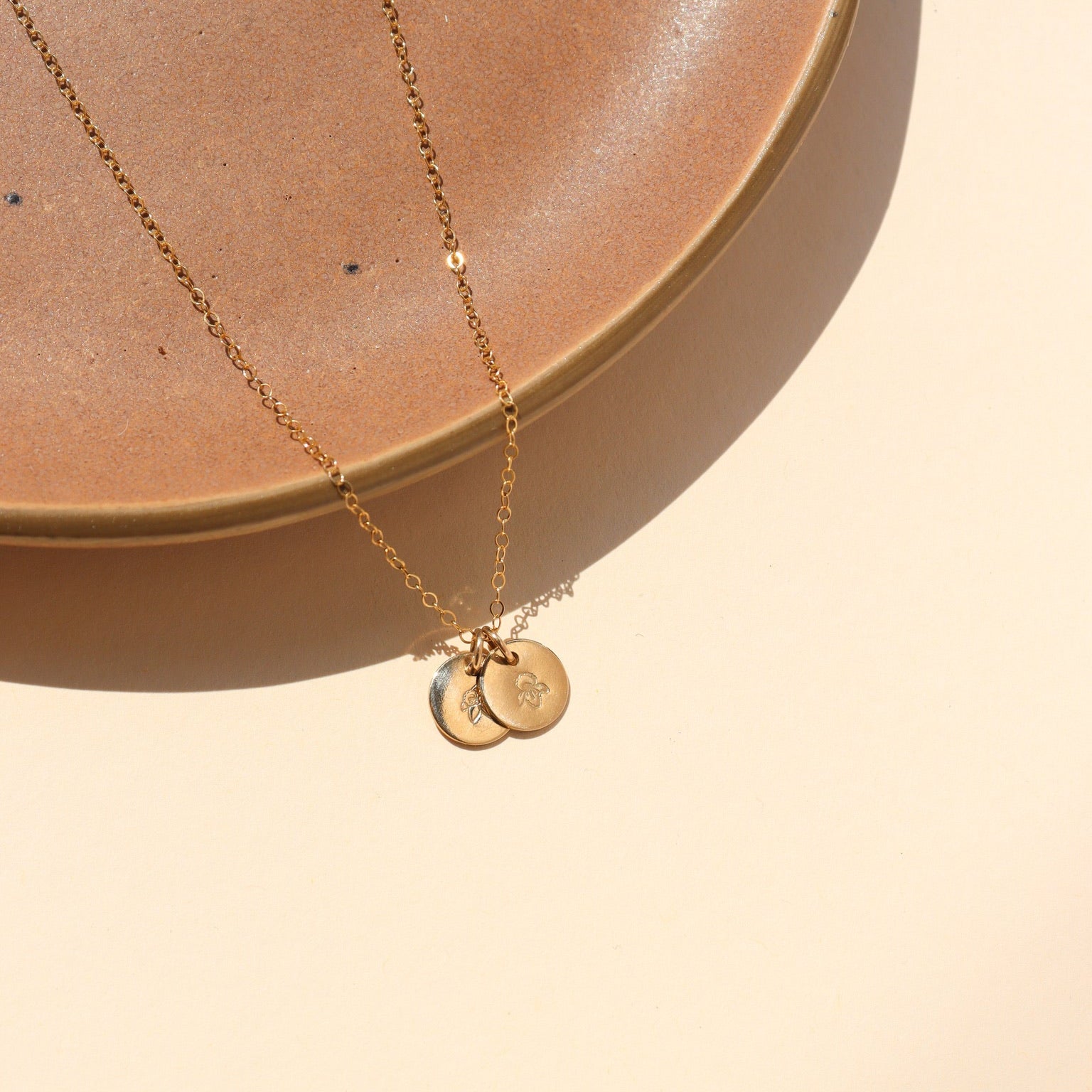 14k gold fill dainty chain necklace with 2 14k gold fill small disk charms that have flowers hand stamped 