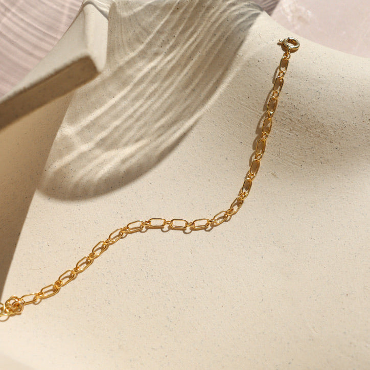 14k gold fill chain bracelet on a light dish