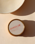 gray candle tin in the sunlight - scent Bungalow
