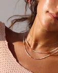 Model wearing  full strand beaded necklace with moonstone, chrysoprase, and carnelian gemstones