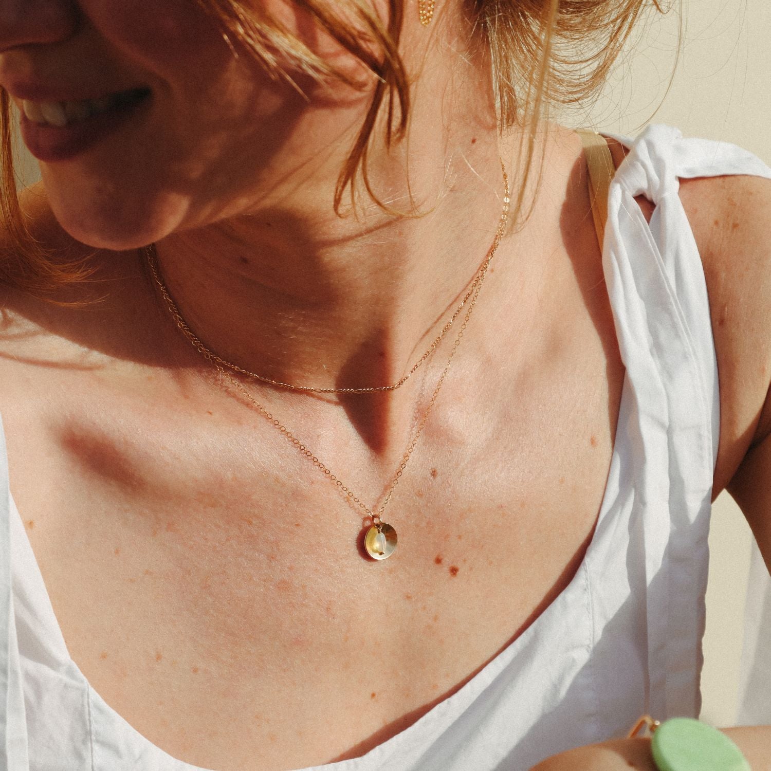 model wearing 14k gold fill delicate chain necklace with opal charm and circle domed charm 
