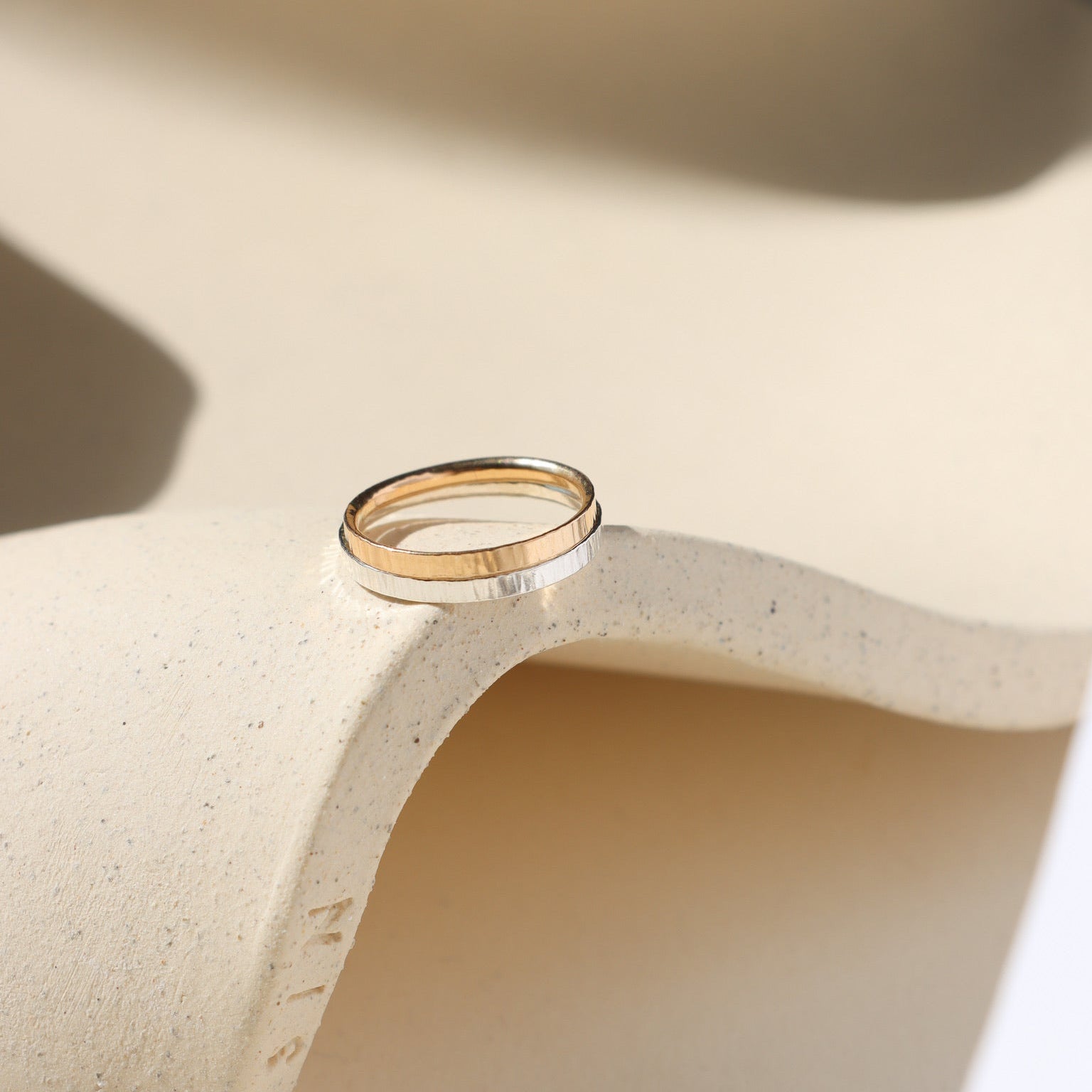 14k gold fill and sterling silver maeve ring stacked together on wavy dish 