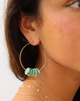 Model wearing Desert Sky Hoops featuring hammered gold filled with teal green turquoise bead accents.