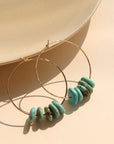 Desert Sky Hoops featuring hammered gold filled with teal green turquoise bead accents.
