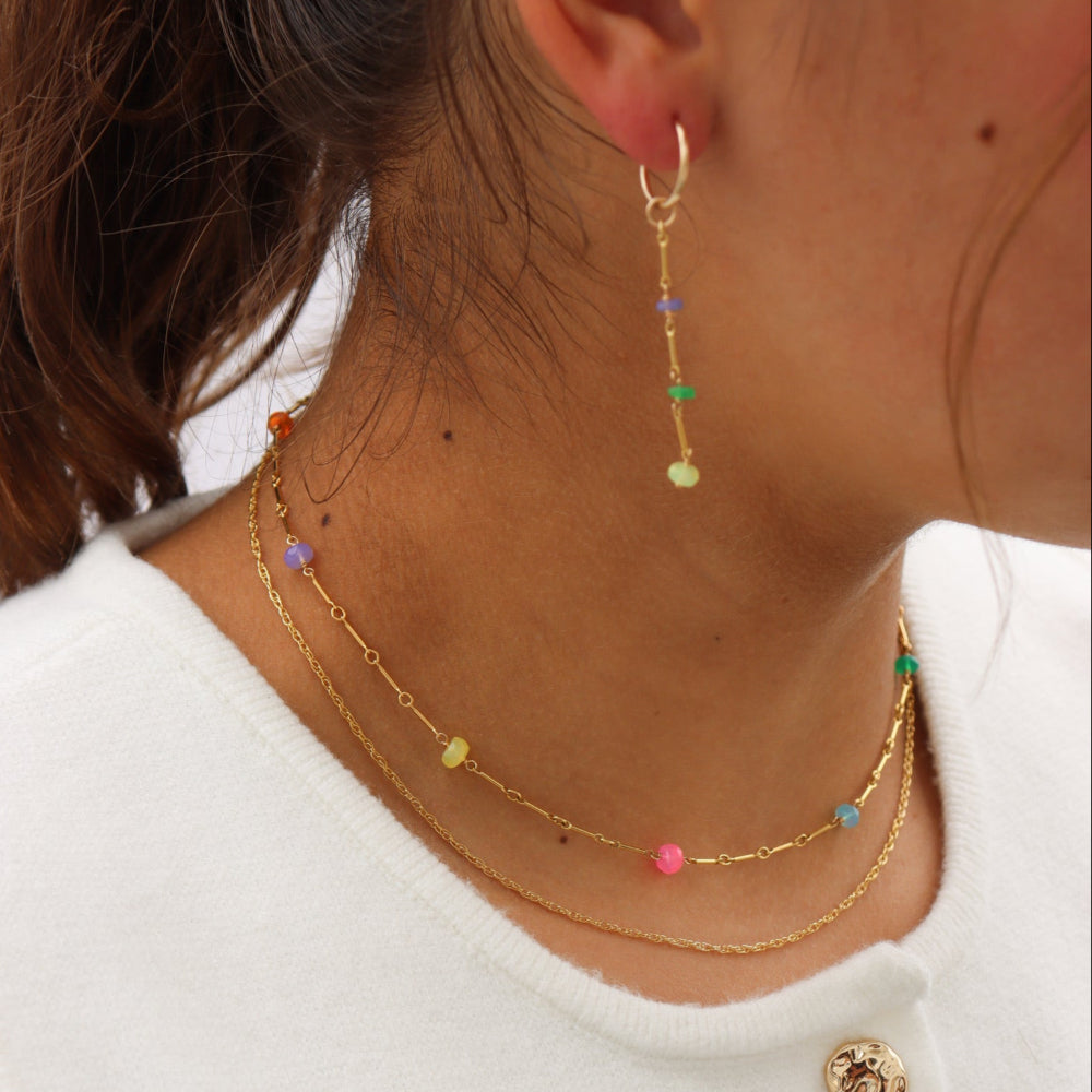 Model wearing a 14k Gold Fill necklace featuring six vibrant opals and a textured chain with bar, dot, and dash links.