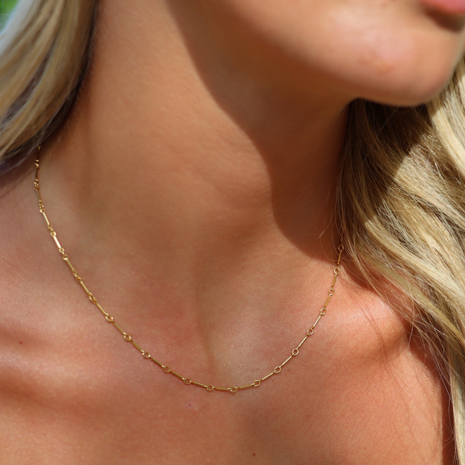 model wearing 14k gold fill bar and link chain necklace 