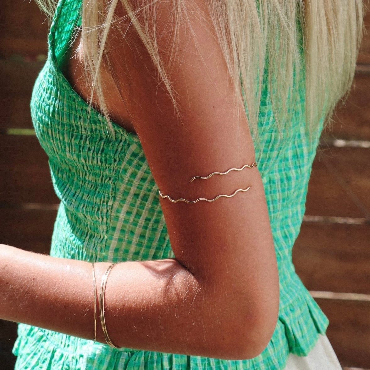 model wearing 14k gold fill wavy arm cuff 
