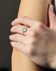 Model wearing a 14k gold fill hammered gold band with a 8mm aquamarine gemstone set in a gold bezel.  