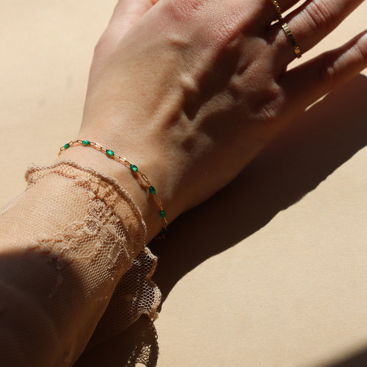 model wearing 14k gold fill gemlink bracelet with emerald