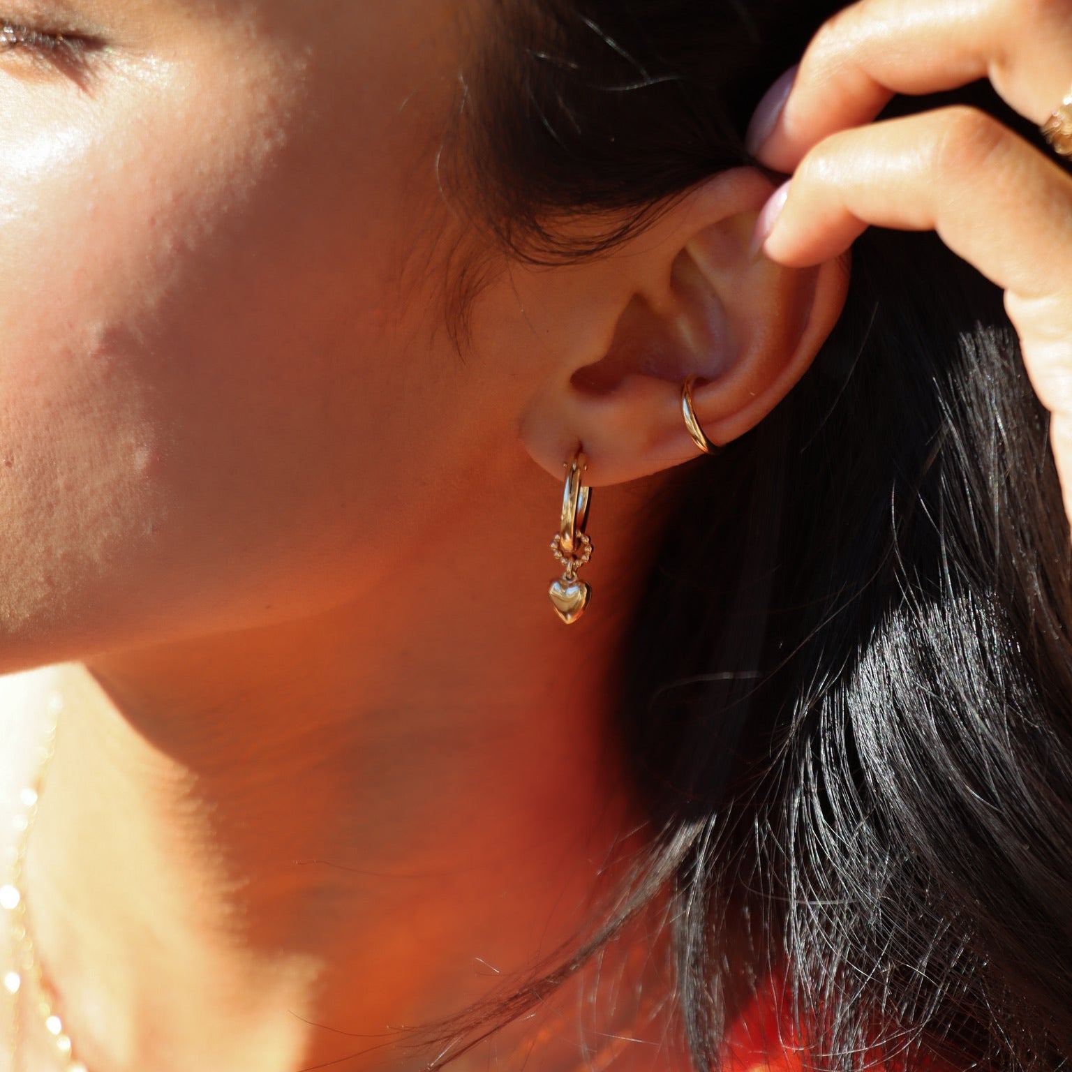 model wearing heart hoop charm in 14k gold fill on classic 14k gold fill hoop paired with 14k gold fill ear cuff