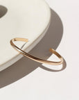 Everyday cuff laid on a white plate in the sunlight