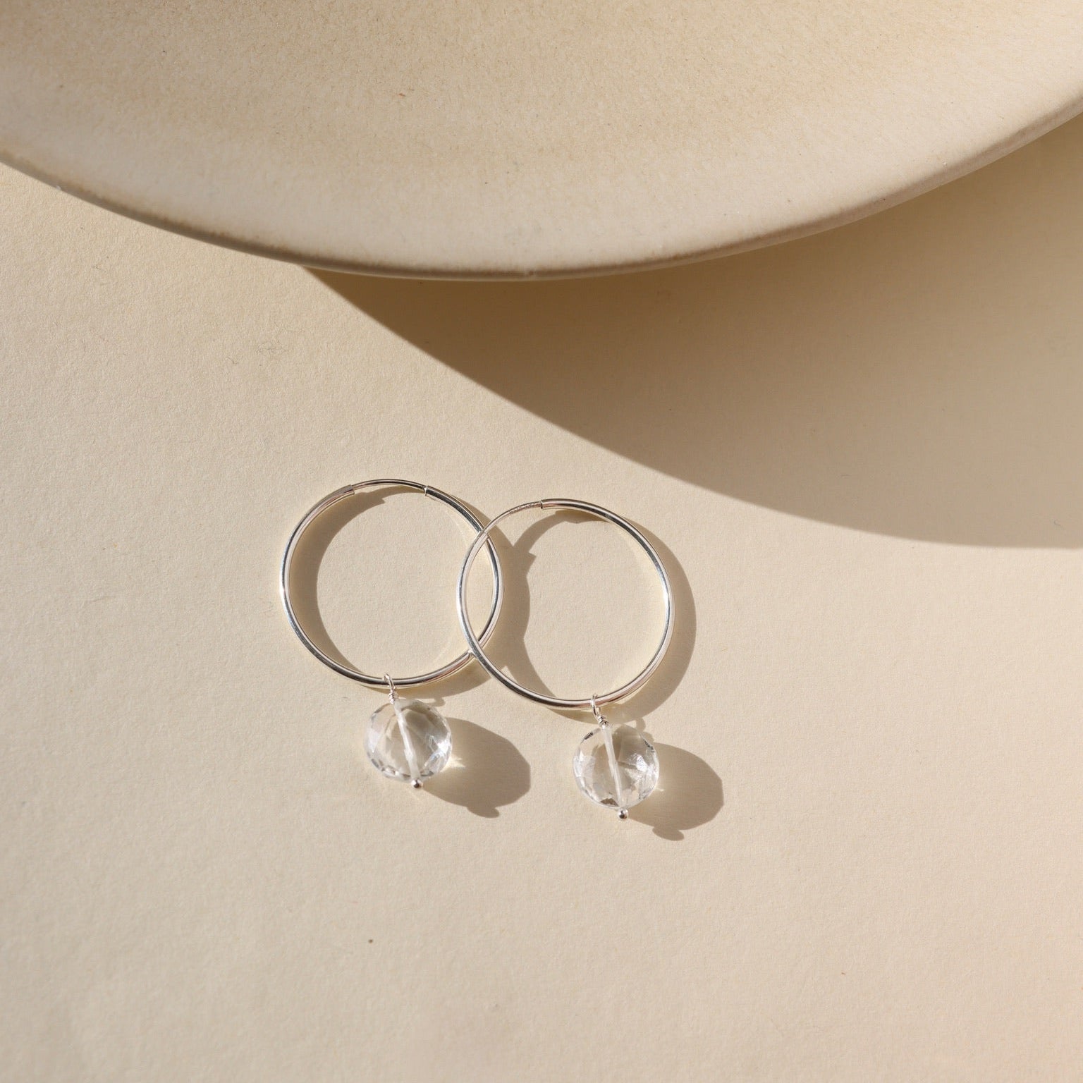 Faceted crystal hoop earrings in sterling silver — elegant, lightweight hoops with sparkling crystal accents.