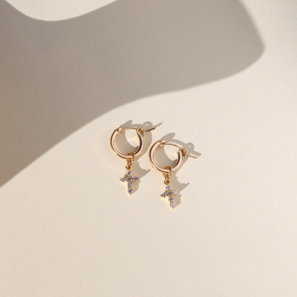 Faith Hoops — 14K gold fill mini hoop earrings with a delicate sparkling cross charm, lightweight and versatile for everyday wear