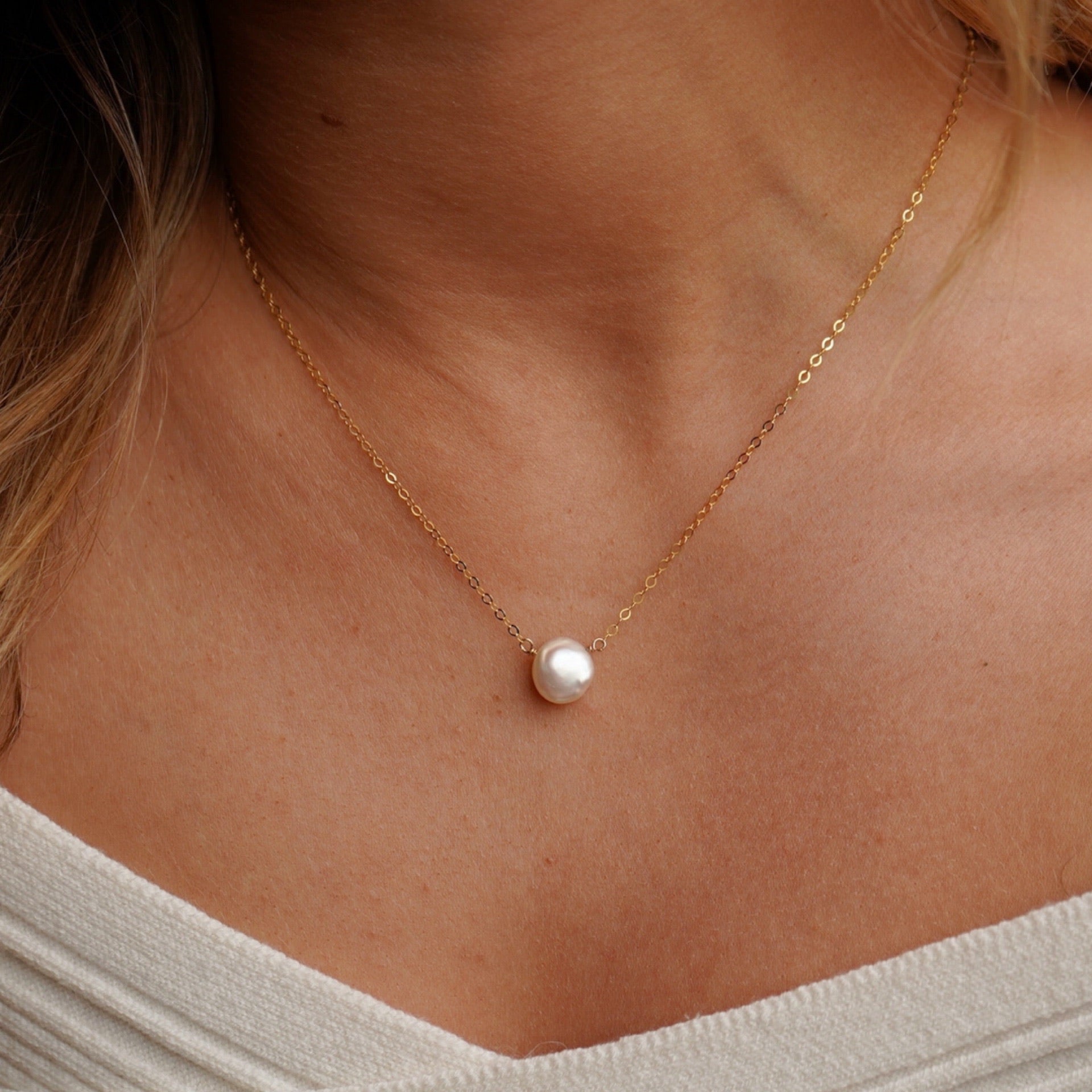 model wearing 14k gold fill delicate chain with freshwater pearl