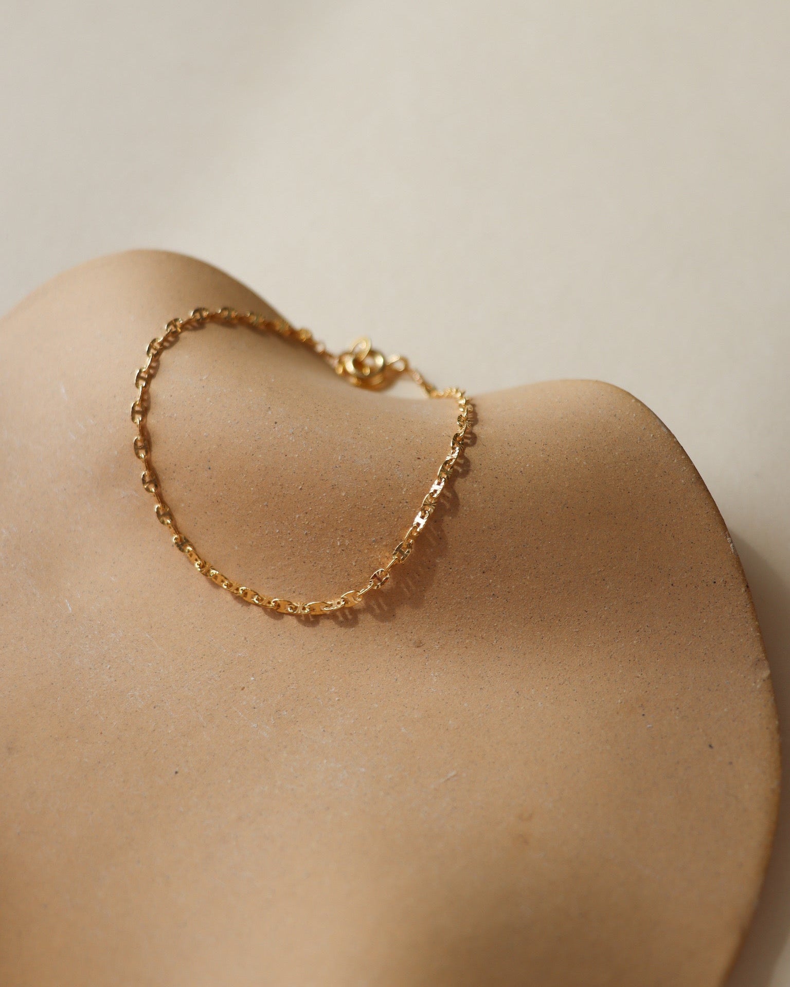 14k gold fill chain bracelet on a light dish